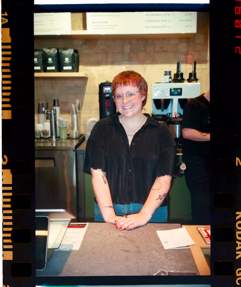 Woman serving coffee and smiling